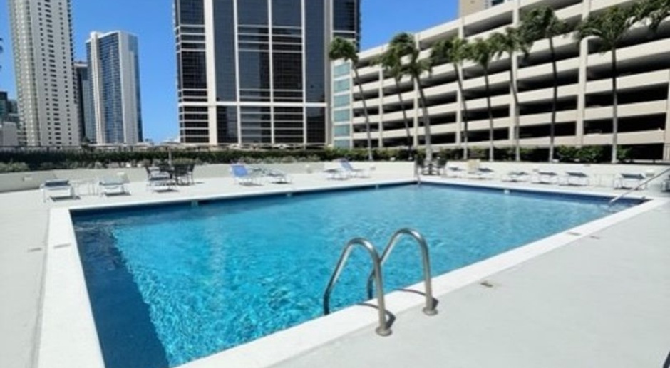 Rarely available corner end 2 bed 2 bath unit with 2 assigned parking stalls on high floor