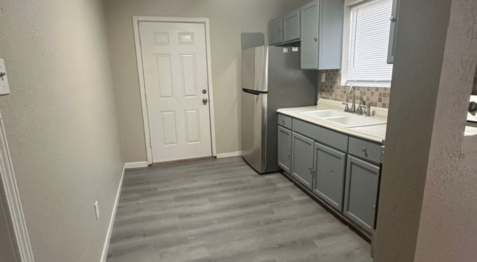 2128 E 82nd Ter | $1000 | 2 Bed, 1 Bath with Attached Garage