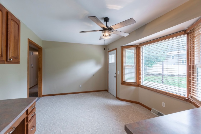 Large home with updated light fixtures, ceiling fans, new flooring and lawncare included!